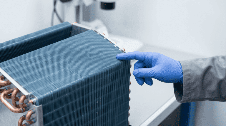Technician inspecting refrigeration unit with blue gloves.