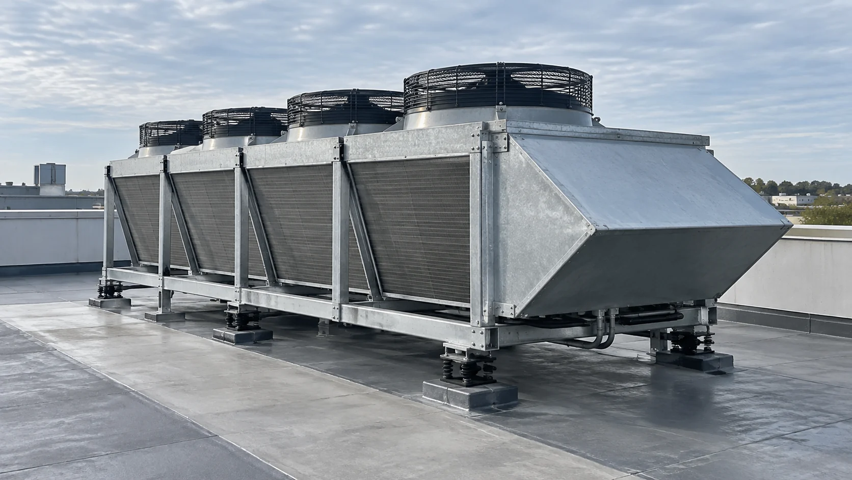 Rooftop condenser fan application Rooftop refrigeration condenser with weather hood, multiple fans, coil sections, vibration isolation and safe maintenance access